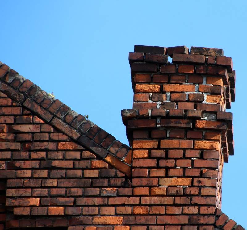 Damaged chimney on an Desoto home showing cracks and missing mortar